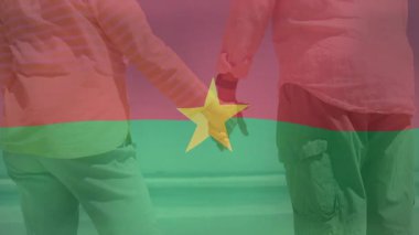 El ele tutuşan, Burkina Faso bayrak animasyonu yapan iki kişi. Birlik, dayanışma, dostluk, çeşitlilik, kültür, vatanseverlik