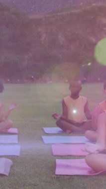 Dışarıda yoga yapan çeşitli öğrencilerin üzerine ışık animasyonu. okul, eğitim, spor ve sağlıklı yaşam tarzı konsepti dijital olarak oluşturulmuş video.