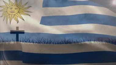 Ön planda haç ve çim siluetiyle Uruguay bayrağı sallıyordu. Vatanseverlik, manzara, kutlama