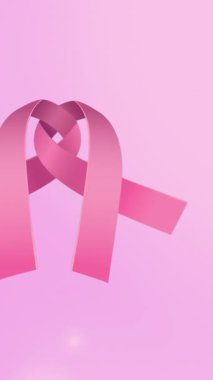 Pembe arka planda pembe kurdele animasyonu. Göğüs kanseri pozitif farkındalık kampanyası konsepti dijital olarak üretildi.