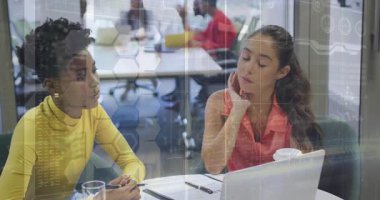 Ofiste dijital veri işleme animasyon örtüsüyle tartışan iki kadın. İş, teknoloji, işbirliği, takım çalışması, veri analizi, yenilik