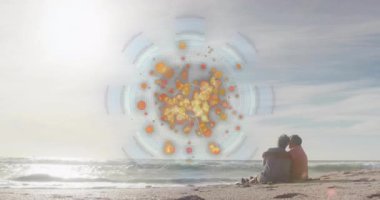 Okyanus dalgaları üzerinde renkli dairesel animasyonlarla sahilde oturan biri. Rahatlama, sükunet, dijital sanat, boş zaman, yaz