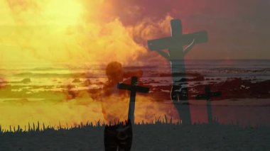 Canlı gün batımına karşı duacı silueti, sahilde haç animasyonu. Maneviyat, inanç, meditasyon, dinginlik, sükunet, doğa