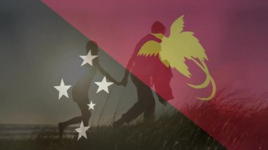Çimenlerin üzerinde yürüyen Papua Yeni Gine bayrağını taşıyan çift. Kültür, gelenek, seyahat, keşif, bayraklar, birlik