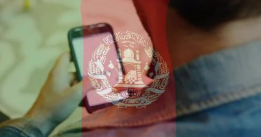 Akıllı telefon kullanarak, okul ortamında Afganistan bayrağının animasyonunu izleyen kişi. Teknoloji, eğitim, vatanseverlik, sınıf, kültür, sembolizm