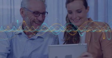 Gülümseyen meslektaşlar renkli dalga animasyonu ile tablet üzerinde verileri tartışıyor. İş, işbirliği, teknoloji, takım çalışması, analitik, yenilik