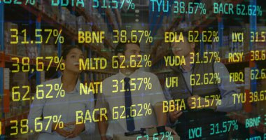 Depodaki stokları kontrol eden çeşitli erkek ve kadın denetçilere karşı borsa verileri işleniyor. lojistik ve ulaşım sektörü kavramı