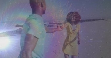 Sahilde el ele tutuşan renkli animasyon efektleri olan bir çift. Romantizm, coşku, aşk, tatil, dijital