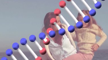 Anne plajda DNA iplikçikli bir bebek taşıyor. Aile, genetik, teknoloji, annelik, ebeveynlik, bilim