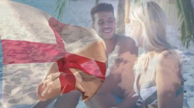 Sahilde dinlenen, animasyon sahnesinde İngiltere bayrağı taşıyan çift. Tatil, seyahat, rahatlama, tatil, boş zaman, vatanseverlik