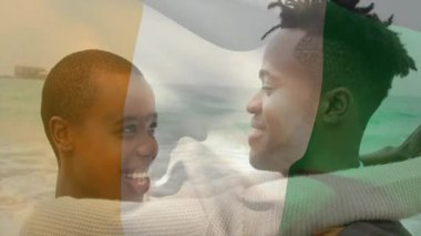 Arka planda İrlanda bayrağı animasyonuyla kucaklaşan çift, birlikte gülümsüyor. Kutlama, vatanseverlik, birliktelik, mutluluk, aşk, ulusal bayrak