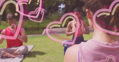 Dışarıda yoga pratiği yaparken, iki insan kalp animasyonu yapıyor. Meditasyon, sağlık, farkındalık, dinginlik, egzersiz, rahatlama