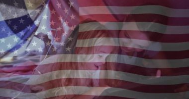 Amerikan bayrağı animasyonu altında çocuklar okul ortamında tablet üzerinde oynuyorlar. Teknoloji, eğitim, çocukluk, öğrenme, vatanseverlik, cihazlar