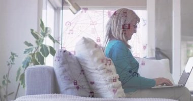 Evde dizüstü bilgisayar kullanan, dijital ağ animasyon simgeleriyle etkileşime giren bir kadın. Teknoloji, ağ, iletişim, yenilik, uzaktan çalışma, ev ofisi