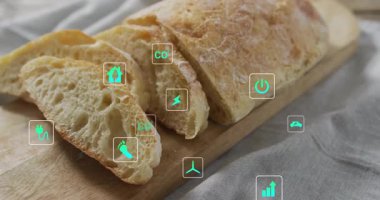 Ahşap tahtada dilimlenmiş ekmek ve çevre dostu ikonlar animasyonu örtüyor. Fırın, organik, sürdürülebilirlik, tazelik, tahıl, toptan gıda