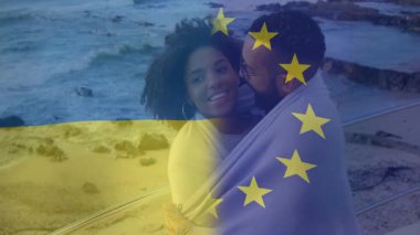 Okyanus tarafından kucaklanan Ukrayna ve AB bayraklı çift animasyon örtüşüyor. Romantizm, birlik, vatanseverlik, aşk, çeşitlilik, uyum.