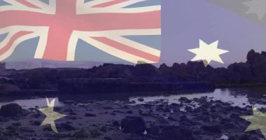 Alacakaranlıkta kayalık kıyı manzarasında animasyonla Avustralya bayrağı sallıyordu. Manzara, kıyı şeridi, akşam, vatanseverlik, okyanus, hareket