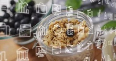 Dijital iş simgeleri masanın üstünde granola ile sahneyi örtüyor. Teknoloji, ikonografi, kahvaltı, beslenme, sağlıklı beslenme