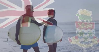 Sahilde, Cayman Adaları bayrağı taşıyan sörfçüler ve arma animasyonu. Sörf, Karayipler, okyanus, dalgalar, macera, seyahat
