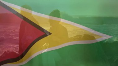 Guyana bayrağı, gün batımı animasyonunda okyanus kıyısındaki siluetli insanları kaplıyordu. Karayipler, ulusal gurur, birlik, sükunet, ufuk, çeşitlilik