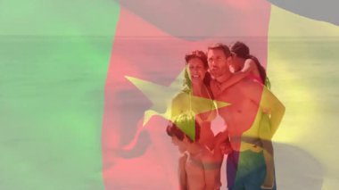 Sahilde, aile animasyonda Kamerun bayrağıyla oynuyor. Kum, tatil, aile zamanı, çocuklar, deniz kenarı, kıyı şeridi.