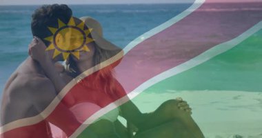 Sahilde dinlenen, Namibya bayrağı animasyon sahnesi olan çift. Tatil, rahatlama, seyahat, turizm, kum, okyanus