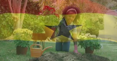 Bitkilerle ilgilenen, bahçedeki canlı bahçıvanla Gana bayrağı animasyonu örtüşüyor. Bahçıvanlık, bahçıvanlık, botanik, ekme, bitki yetiştirme.