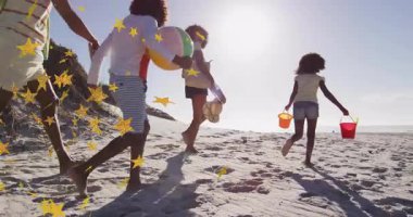 Aile plaj gününün keyfini çıkarırken yıldız animasyonu güneşli sahneyi kaplıyor. Tatil, aile zamanı, deniz kenarı, yaz zamanı, boş zaman, dinlenme.