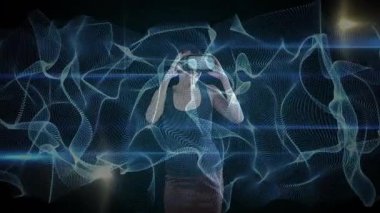 VR kulaklık takan, dijital animasyon ve ışık efektleriyle etkileşime giren biri. Sanal gerçeklik, teknoloji, yenilik, sürükleyici, fütüristik, etkileşim