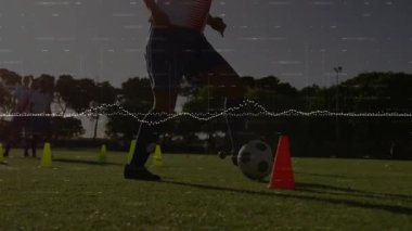 Sahada futbol antrenmanı, animasyon veri görselleştirmesi yapan oyuncular. Spor, teknoloji, veri analizi, takım çalışması