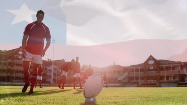 Sahada ragbi topu tekmelemek, arka planda bayrak animasyonu olan oyuncu. Spor, atlet, yarışma, aksiyon, takım, açık hava