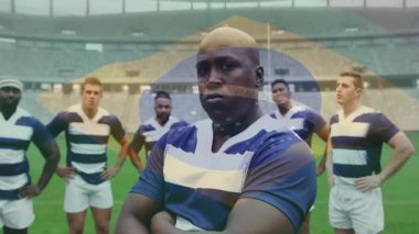 Sahada kendine güvenen Brezilya bayrağı animasyonu eşliğinde ragbi takımı. Takım çalışması, spor, sporcular, vatanseverlik, zafer, birlik