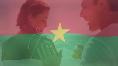 Müzik dinleyen, Burkina Faso bayrak animasyonu yapan çift. Bayraklar, ulusal, çeşitlilik, kutlama, kültür, etnik