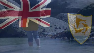 Kayalık sahilde yürüyen, İngiliz ve Anguilla 'lı kişi animasyon örtüsü taşıyor. Deniz kenarı, kıyı, keşif, macera, doğa, vatanseverlik.