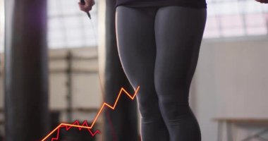 Atlama halatıyla egzersiz yapan kişi, dalgalanan borsa animasyonlarıyla örtüşüyor. Fitness, finans, yatırım, atlama, ekonomi, çalışma