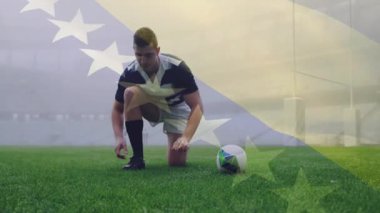 Rugby topunu sahada tutuyor, arka planda bayrak animasyonu olan bir oyuncu. Spor, atlet, yarışma, takım çalışması, açık hava