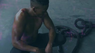 Yere çömelmiş, kısa saçlı, odaklanmış ve kararlı görünen üstsüz bir adam. Fitness, konsantrasyon, güç, kararlılık, atletik, egzersiz