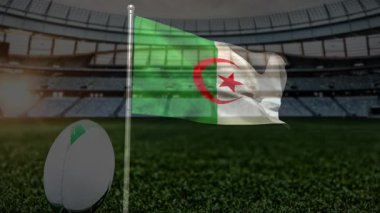 Rugby sahasında arka planda stadyumla Cezayir bayrağı sallıyordu. Spor, vatanseverlik, takım ruhu, ulusal bayrak