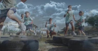 Lastik engelli parkurunda koşmak, çocuklar okulda bulutlu gökyüzünün altında oynamak. Egzersiz, oyun alanı, çocuklar, takım çalışması, aktivite, fitness