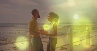 Sahilde, ışıldayan ışık animasyon efektleriyle mutlu bir an yaşayan bir çift. Tatil, seyahat, tatil, gün batımı, mutluluk, romantizm