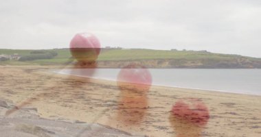 Pembe lolipoplar sakin deniz manzarasının üzerinde sakin suyla canlanıyor. Şeker, şekerleme, tatlı, plaj manzarası, huzur, huzur