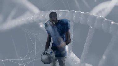 DNA ipliği ve ağ bağlantıları üzerinden mavi formalı futbolcu. Futbol, atlet, teknoloji, yenilik, genetik, dijital