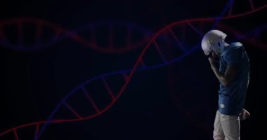 Futbolcu, arka planda DNA ipliği animasyonu olan topu tutuyor. Sporcu, spor, genetik, biyoloji, yenilik, fitness