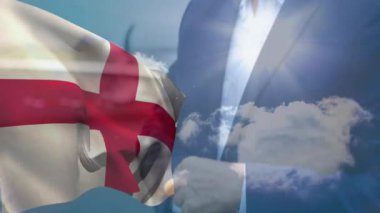 Bulutlu arka planı olan takım elbiseli bir adamın üzerinde İngiliz bayrağı sallıyor. Vatanseverlik, milliyetçilik, iş dünyası, resmi, hava durumu, açık hava