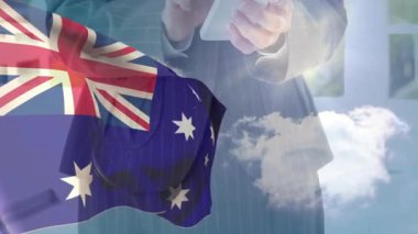 Arka planda bulutlu gökyüzü olan Avustralya bayrağı kaplamalı akıllı telefon kullanan kişi. Teknoloji, bağlantı, vatanseverlik, ulusal, iletişim, bulutlu