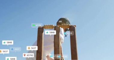 Sallanan sopa, açık havada sosyal medya simgelerinin canlandırılmasıyla kriket oyuncusu. Spor, dijital, teknoloji, atlet, bulutlar, açık hava