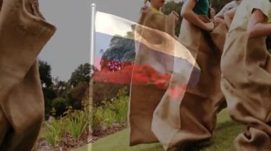 Çuval yarışına katılan, okul etkinliklerinde Polonya bayrağı animasyonu olan çocuklar. Spor, rekabet, çocukluk, takım çalışması, açık hava, kutlama