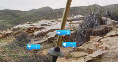 Çimen ve dağlarla kaplı kayalık arazide sosyal medya bilgilendirmeleri. Doğa, açık hava, teknoloji, dijital, manzara, çevre