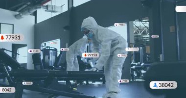 Spor salonunda, koruyucu takım elbiseli insanlar temizlik ekipmanlarını animasyon kaplama ile temizlerler. Dezenfekte, hijyen, sağlık, sağlık, güvenlik