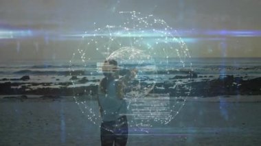 Dijital ağ arayüzü ile etkileşim, sahilde animasyonla ayakta duran kişi. Teknoloji, yenilik, bağlantı, yaratıcı, etkileşimli, sanal